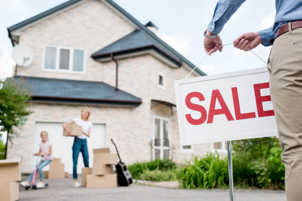 can you sell a house with a mortgage? House with Sale sign 